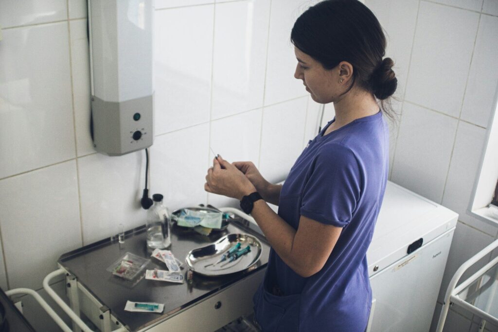 Nurse preparing medical supplies on a tray